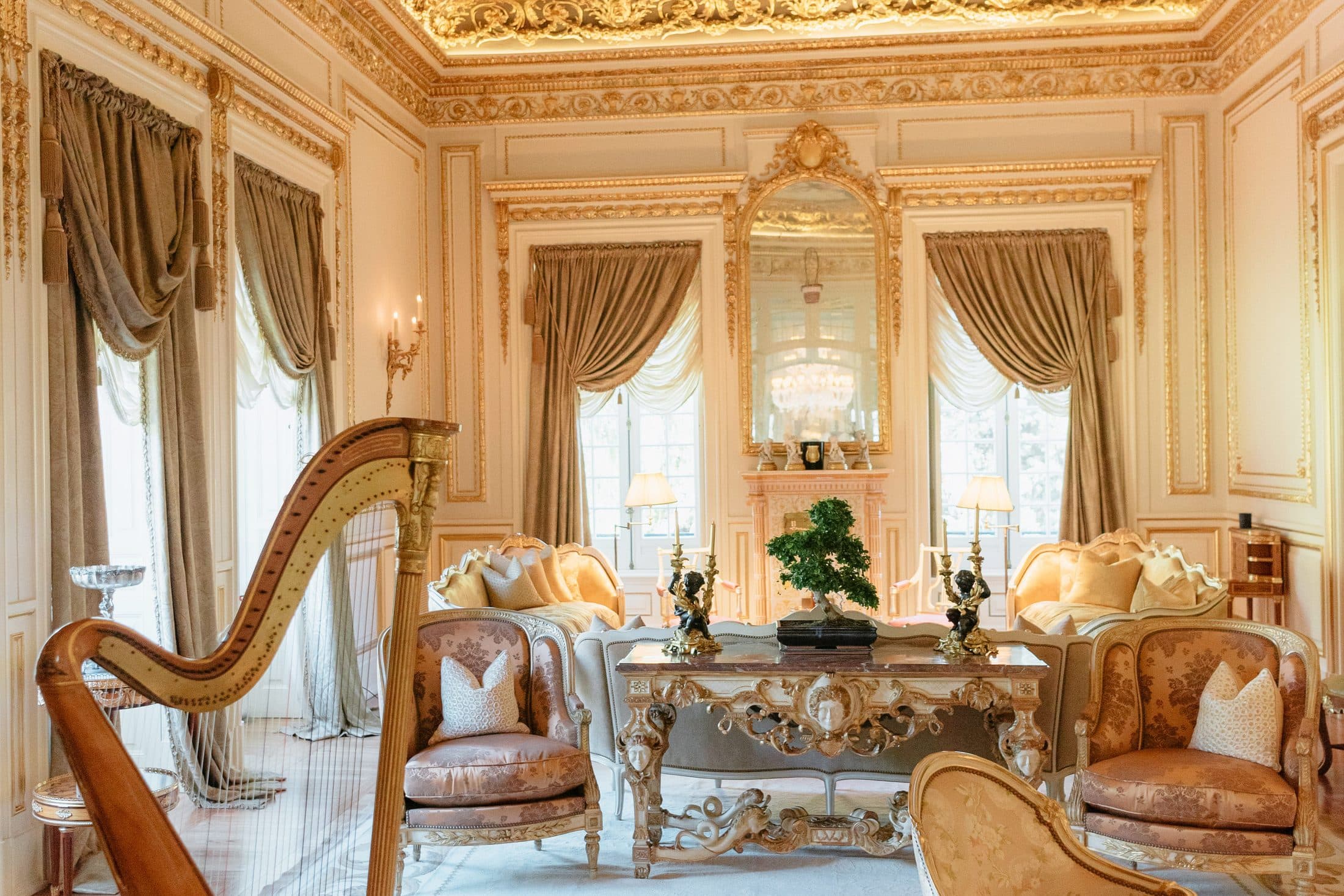A gilded salon with a harp — dense, difficult color a sensor can drift on